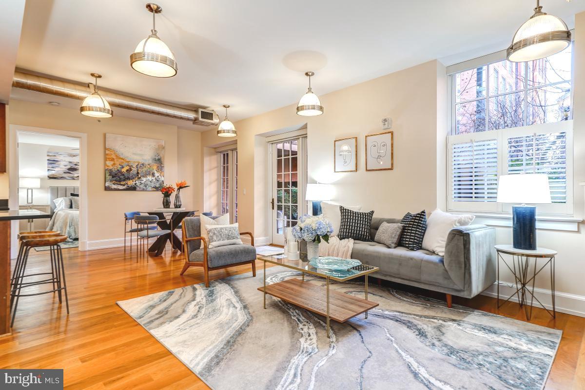 215 I Street Northeast, Unit 111 Washington, DC 20002 - Photo 33 of 34 a living room with furniture wooden floor and a chandelier