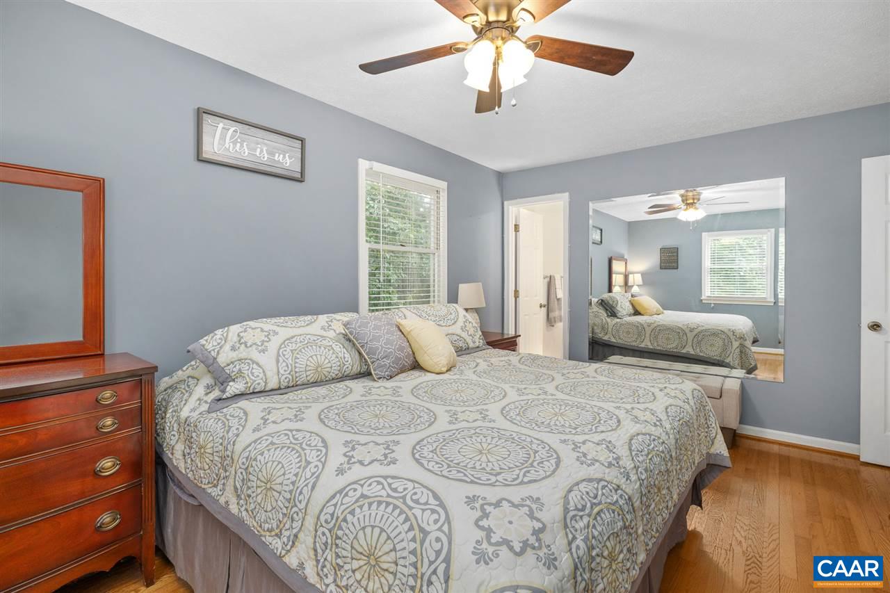 949 Chapman Road Stanardsville, VA 22973 - Photo 15 of 41 a bedroom with a large bed and a chandelier