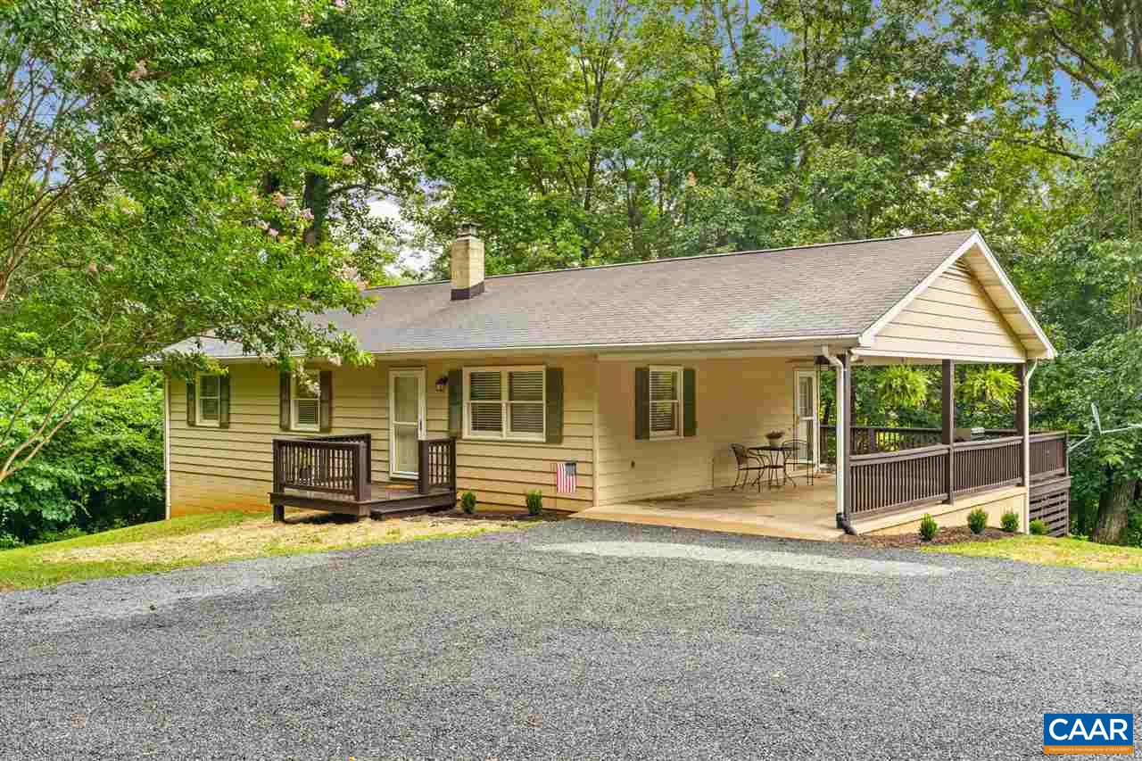 949 Chapman Road Stanardsville, VA 22973 - Photo 2 of 41 a front view of a house with a garden and outdoor seating