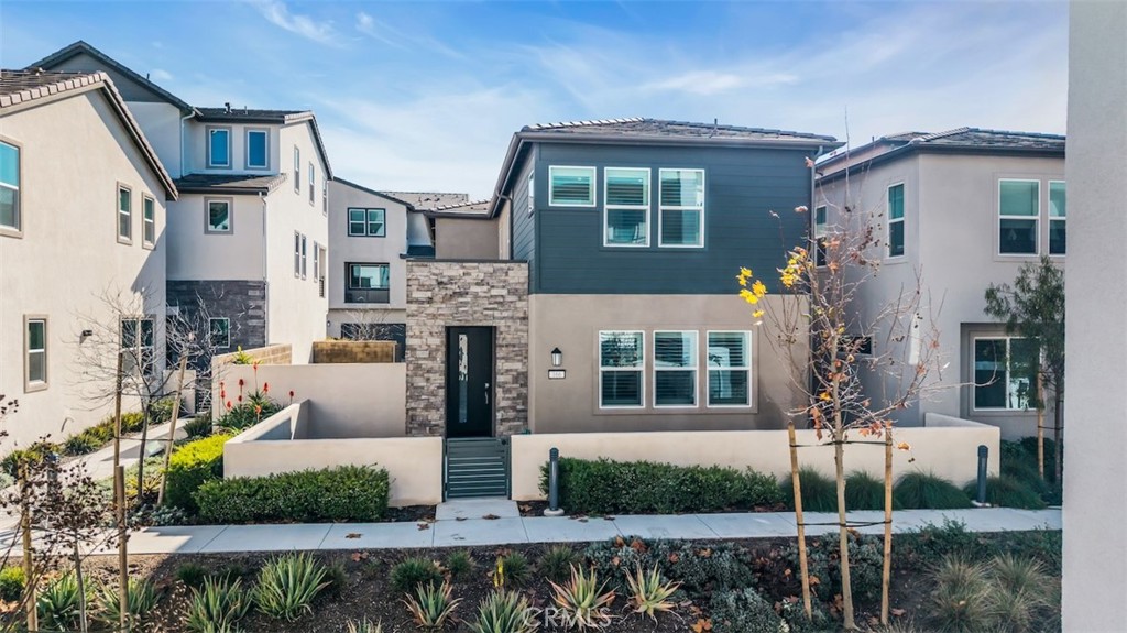 a front view of a house with a garden