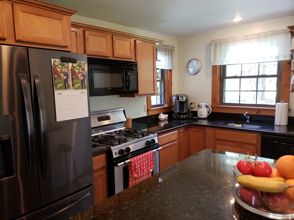 67 Keyes Road Holyoke, MA 01040 - Photo 3 of 28 a kitchen with stainless steel appliances kitchen island granite countertop a refrigerator stove and sink