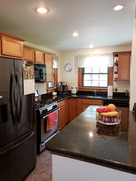 67 Keyes Road Holyoke, MA 01040 - Photo 5 of 28 a kitchen with stainless steel appliances granite countertop a sink a stove and a refrigerator