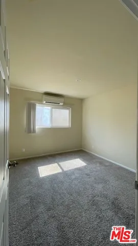 a view of an empty room and a window