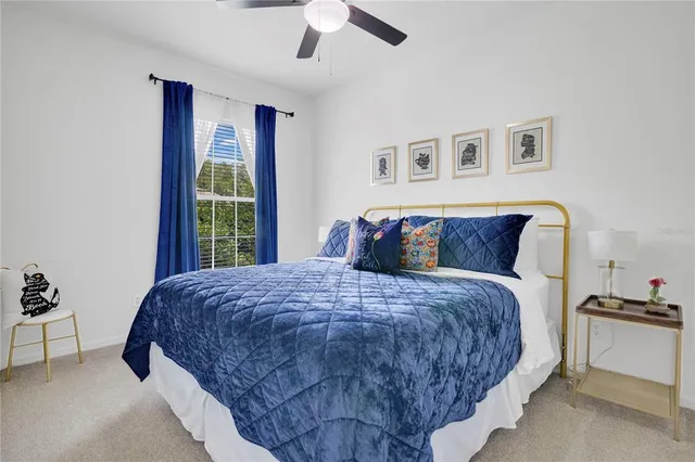 a bedroom with a large bed and a chandelier