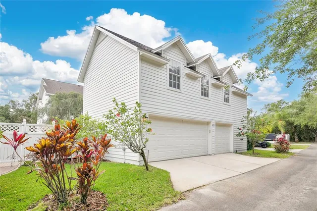 a front view of a house with a yard and a garage