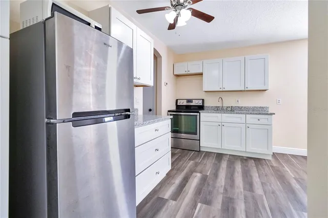 a kitchen with stainless steel appliances a refrigerator sink and cabinets