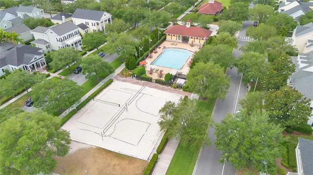 an aerial view of residential house with outdoor space and trees all around