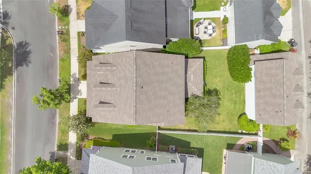 an aerial view of a house with a yard