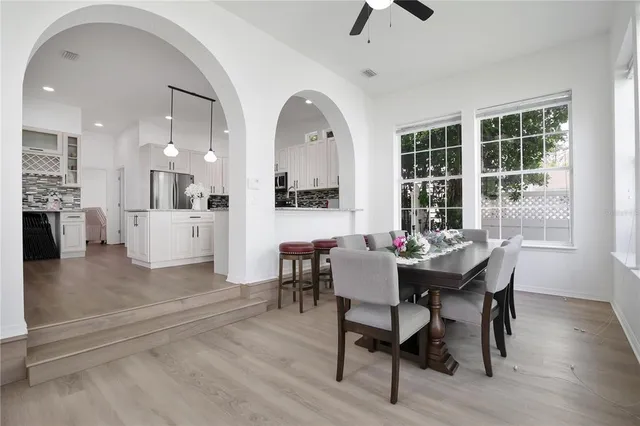 a view of a dining room with furniture and wooden floor