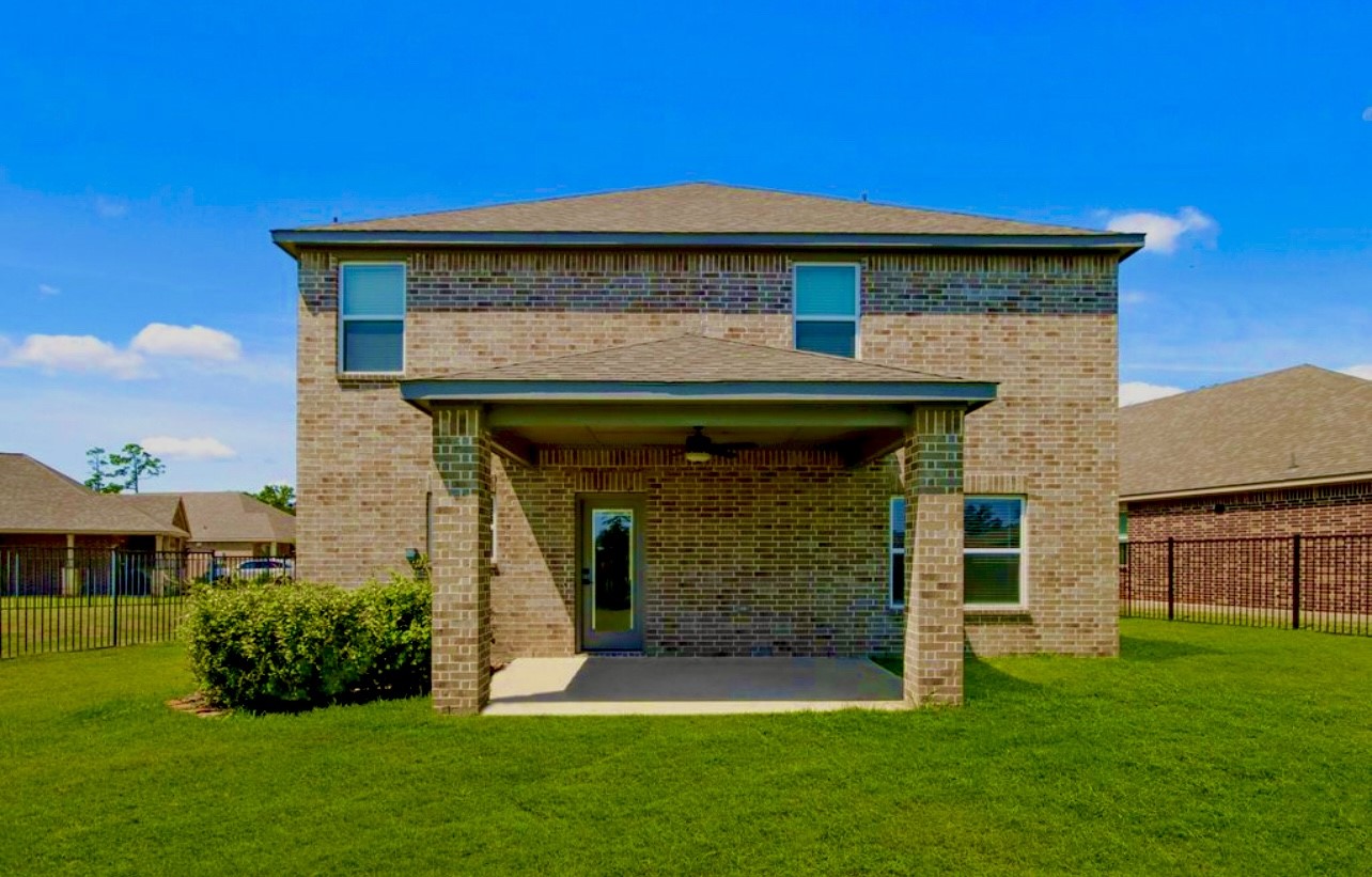 708 Fallen Hemlock Court Conroe, TX 77304 - Photo 12 of 15 a front view of a house with a yard