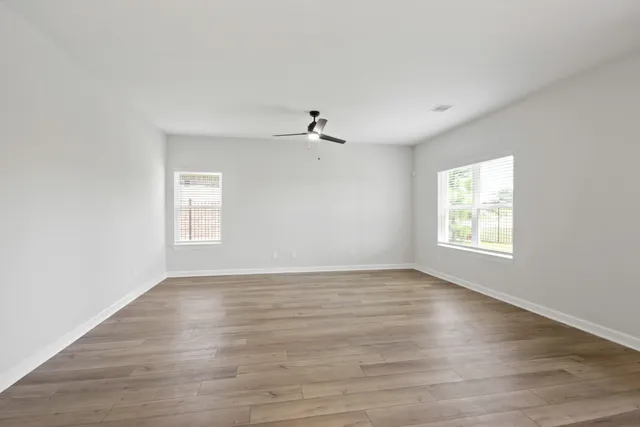 wooden floor in an empty room with a window