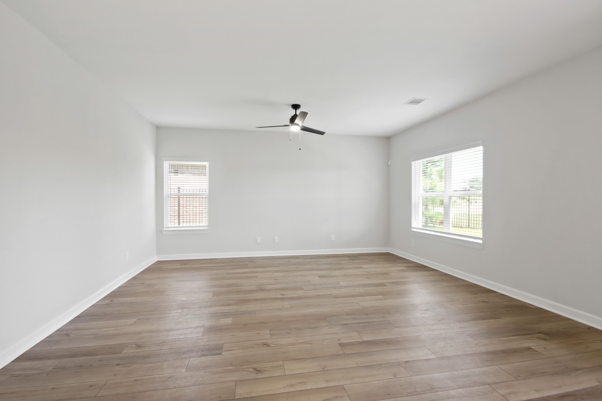 708 Fallen Hemlock Court Conroe, TX 77304 - Photo 3 of 15 wooden floor in an empty room with a window