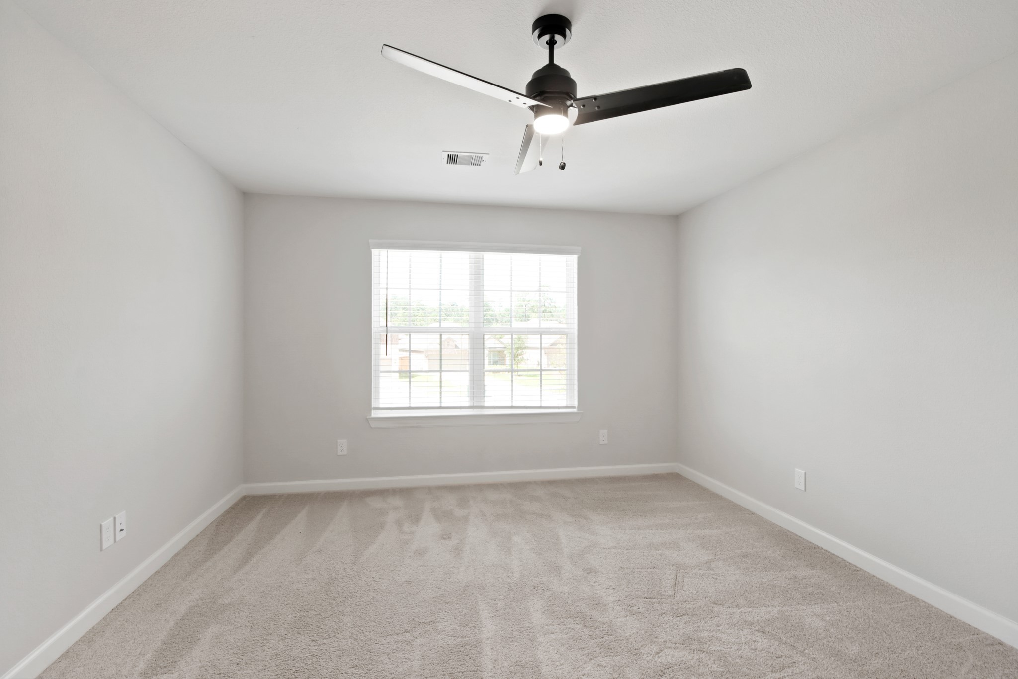 708 Fallen Hemlock Court Conroe, TX 77304 - Photo 7 of 15 an empty room with a window and a fan