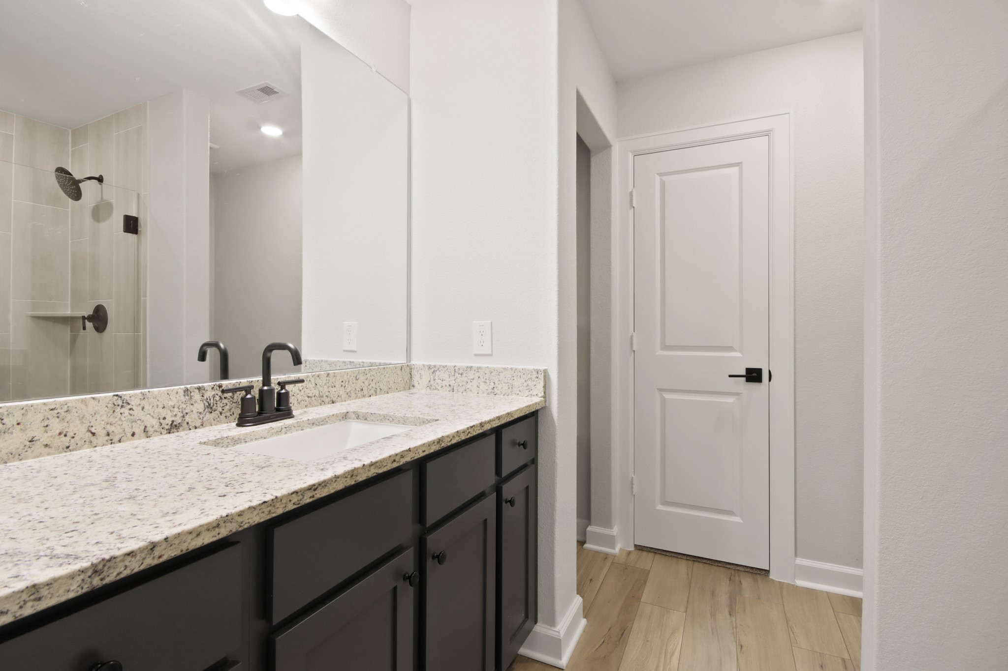 708 Fallen Hemlock Court Conroe, TX 77304 - Photo 9 of 15 a bathroom with a granite countertop sink and a mirror