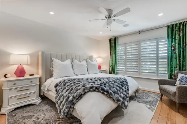 a bedroom with a large bed and a chandelier
