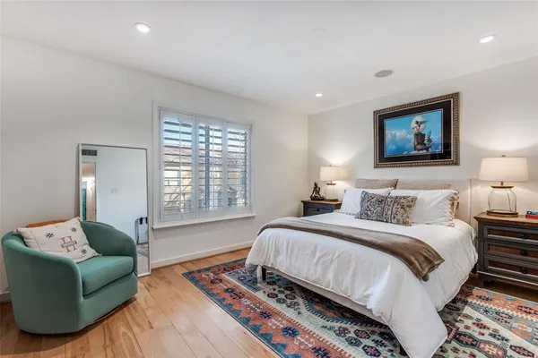 a bedroom with a large bed and a couch