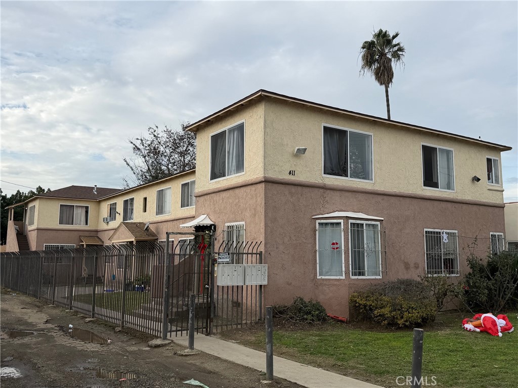 411 North Chester Avenue Compton, CA 90221 - Photo 2 of 6 a yellow house with table and chairs