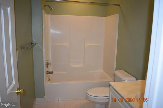 a bathroom with a toilet and a bath tub