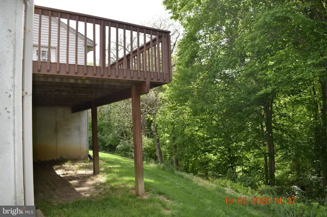 a view of a porch with a floor to ceiling window and a yard