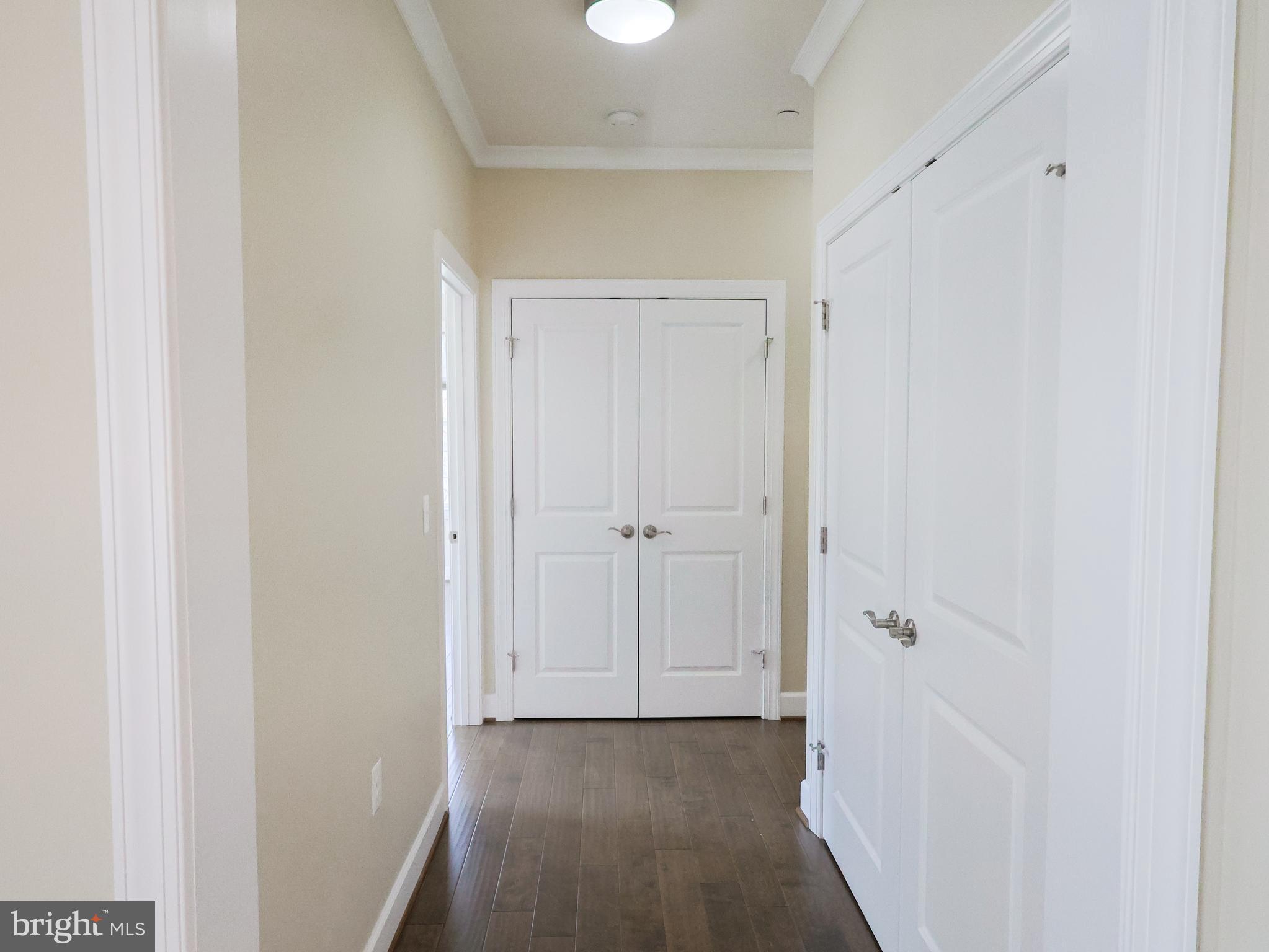 10530 Resort Road, Unit 102 Ellicott City, MD 21042 - Photo 22 of 41 Hallway with laundry and linen closet