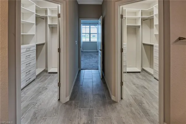 a view of a hallway with wooden floor and closet