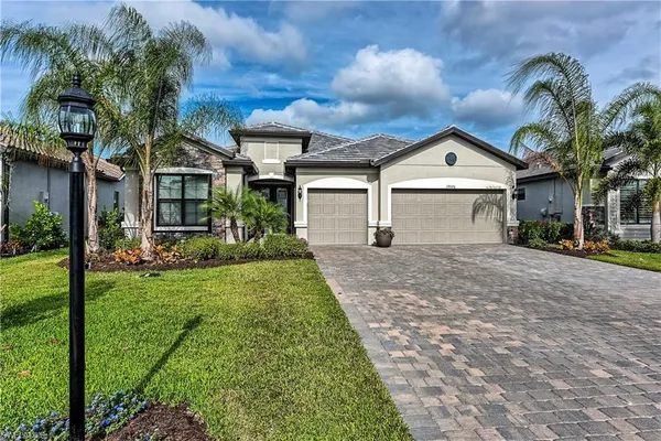 a front view of a house with a yard and garage