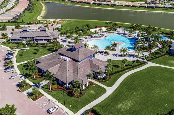 an aerial view of a house with a garden and lake view