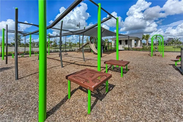 a view of an chairs and bench in the yard