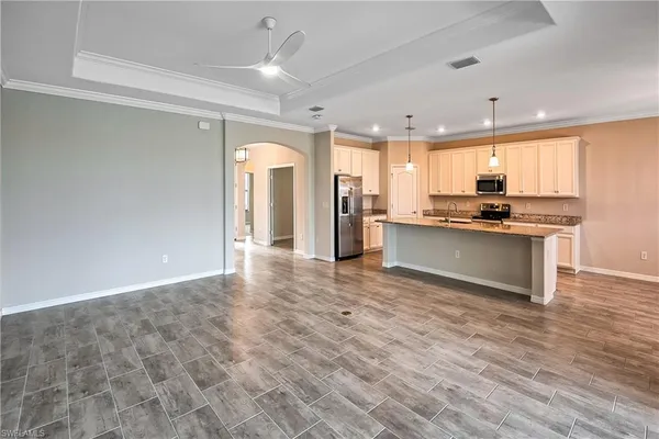 a kitchen with stainless steel appliances granite countertop a stove a sink and a refrigerator