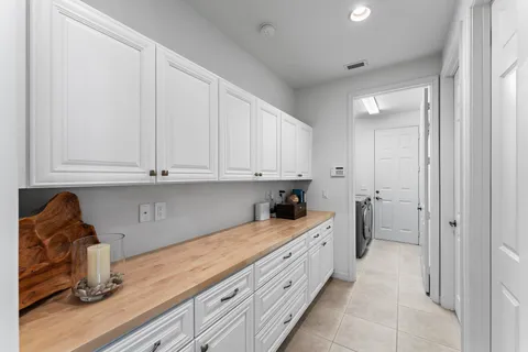 a kitchen with granite countertop white cabinets and sink