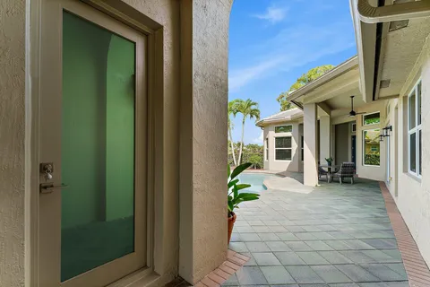 a view of a house with potted plants