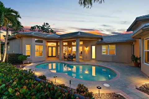 a view of a porch with a table and chairs