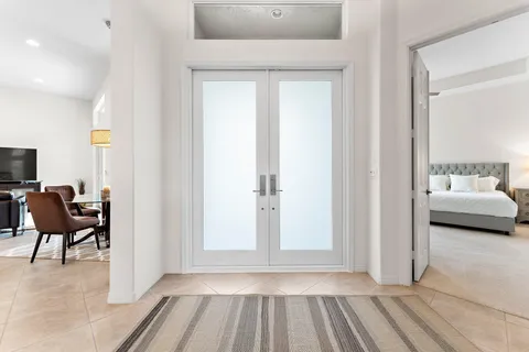 a view of a bedroom with furniture and window