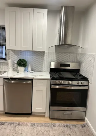 a kitchen with stainless steel appliances granite countertop a stove and a sink