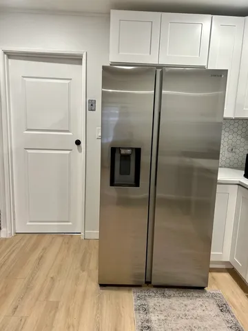a refrigerator freezer sitting inside of a kitchen