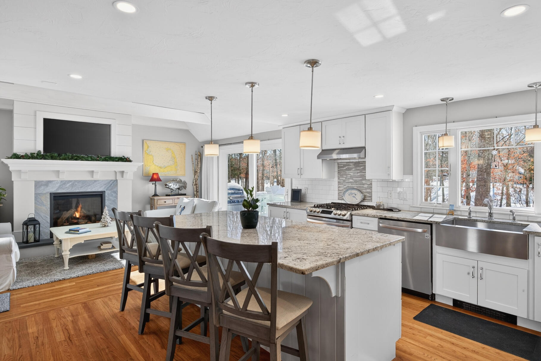 48 Holly Ridge Drive Sandwich, MA 02563 - Photo 12 of 48 a kitchen with stainless steel appliances granite countertop a stove top oven a sink a dining table and chairs