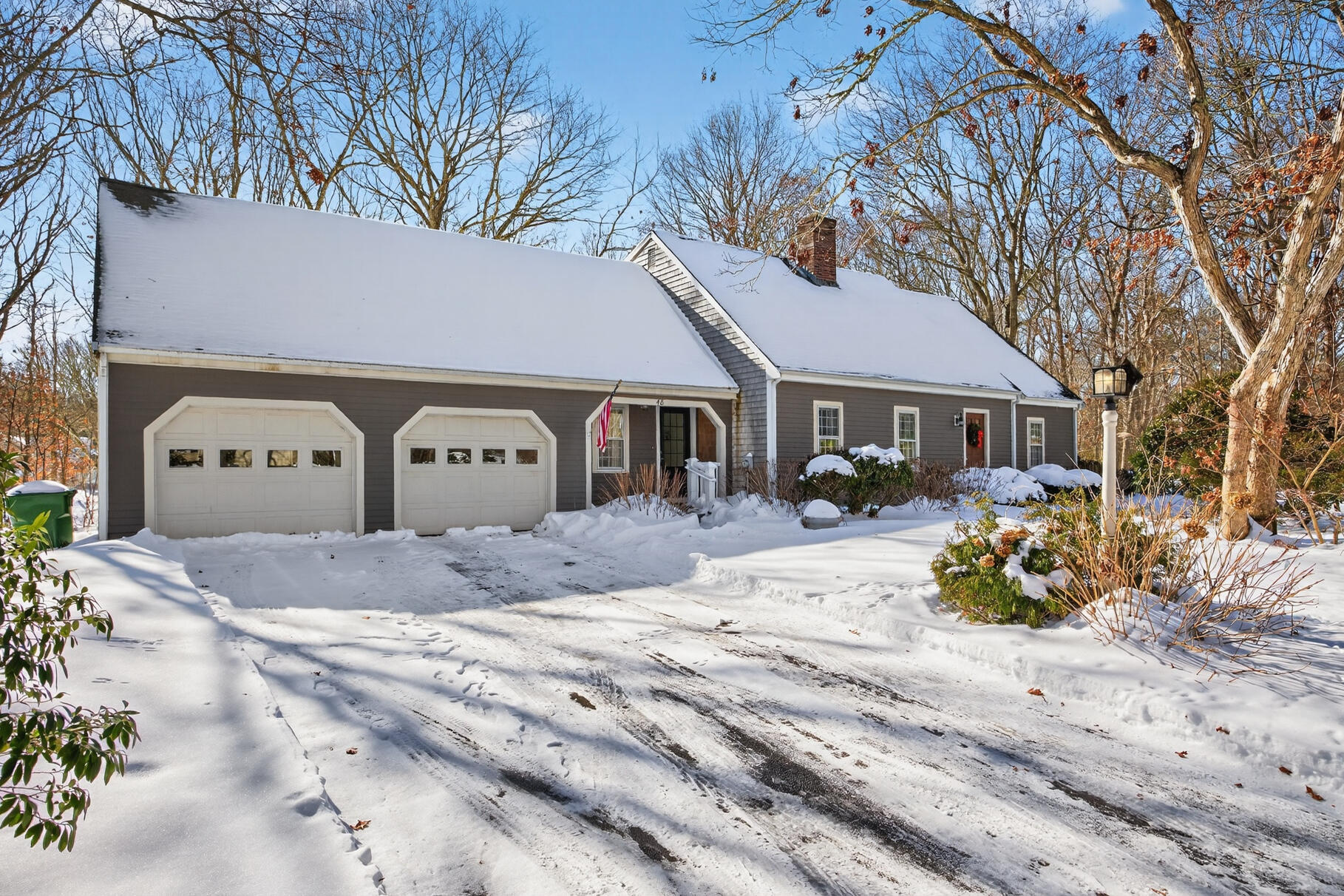 48 Holly Ridge Drive Sandwich, MA 02563 - Photo 39 of 48 a front view of a house with a yard covered with snow and cars parked