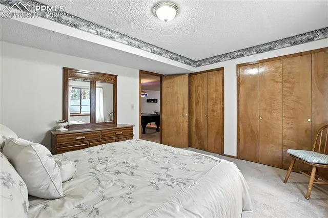 a bedroom with a bed dresser and a window