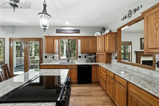 a large kitchen with granite countertop a stove and a sink