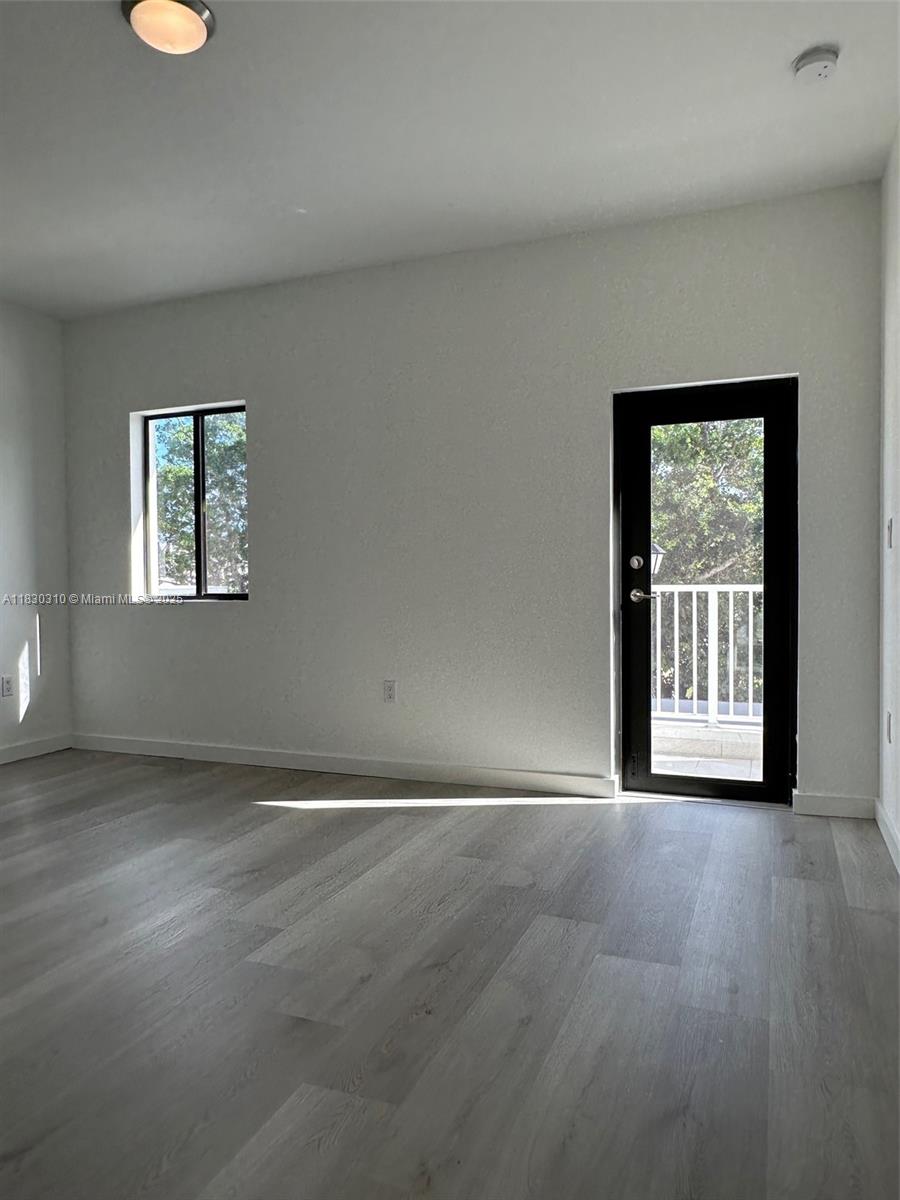 25338 Southwest 135th Avenue, Unit 107 Homestead, FL 33032 - Photo 20 of 26 an empty room with windows