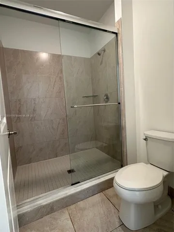 a bathroom with a shower and a toilet