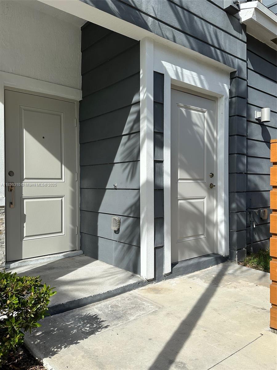 25338 Southwest 135th Avenue, Unit 107 Homestead, FL 33032 - Photo 3 of 26 a view of entrance gate of a house
