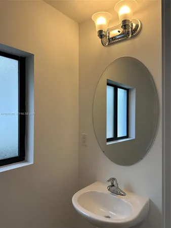 a bathroom with a sink a mirror and a toilet
