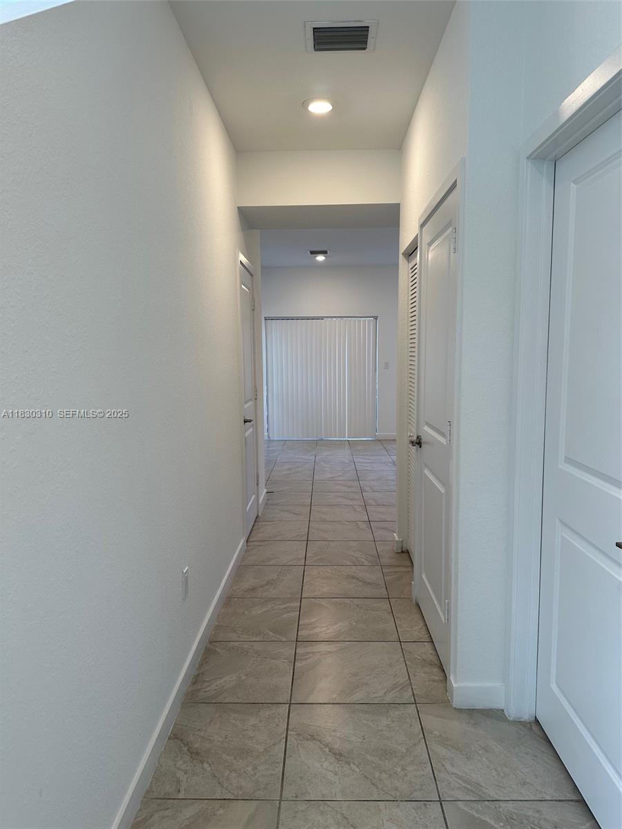 25338 Southwest 135th Avenue, Unit 107 Homestead, FL 33032 - Photo 9 of 26 a bathroom with a sink and a mirror