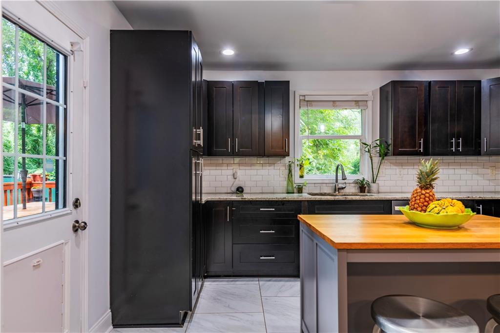 1760 Rogers Avenue Southwest Atlanta, GA 30310 - Photo 19 of 57 a kitchen with a sink a window and cabinets