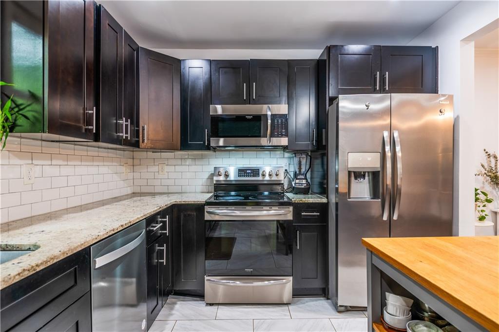 1760 Rogers Avenue Southwest Atlanta, GA 30310 - Photo 20 of 57 a kitchen with a sink stove and refrigerator