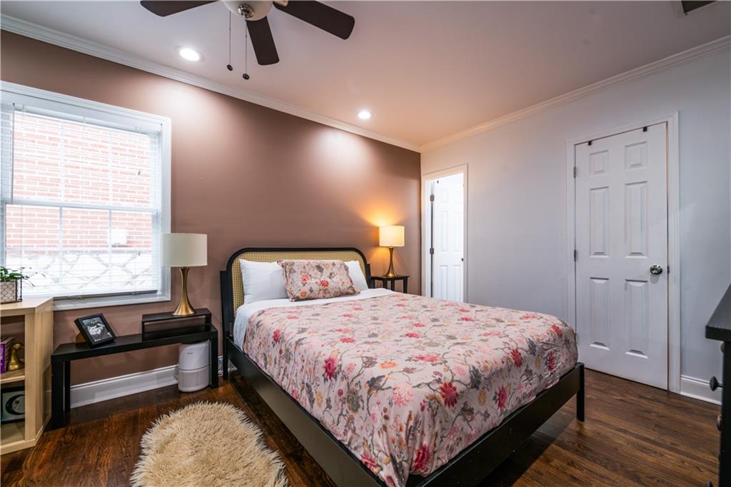 1760 Rogers Avenue Southwest Atlanta, GA 30310 - Photo 23 of 57 a bedroom with a bed and wooden floor