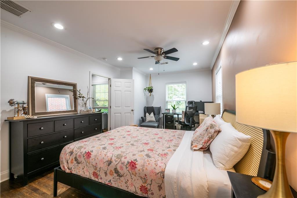 1760 Rogers Avenue Southwest Atlanta, GA 30310 - Photo 25 of 57 a bedroom with a bed and a dresser with mirror