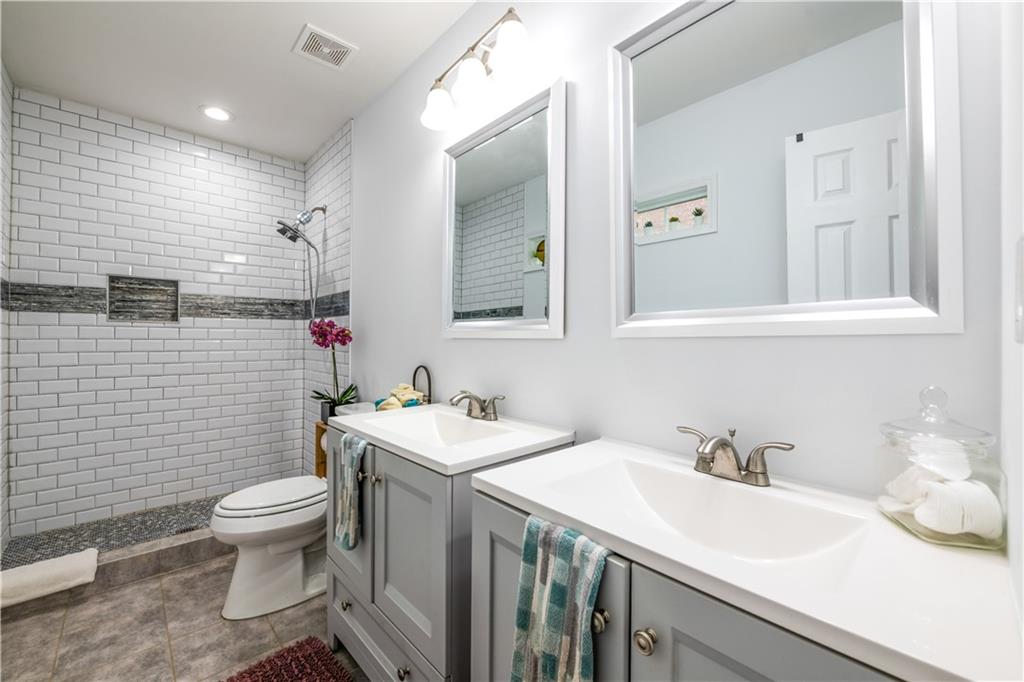 1760 Rogers Avenue Southwest Atlanta, GA 30310 - Photo 29 of 57 a bathroom with a sink a toilet and mirror