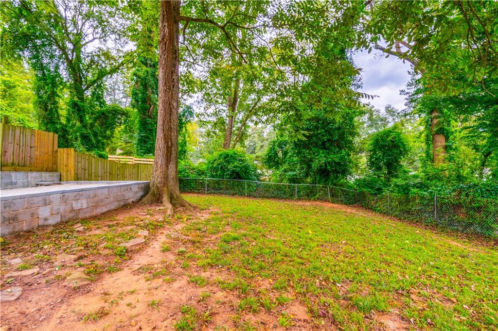 1760 Rogers Avenue Southwest Atlanta, GA 30310 - Photo 53 of 57 a view of a backyard with large trees and a small yard